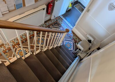 The image show our homes entryhall and stairs including Stair Lift